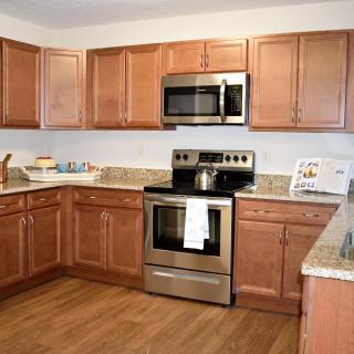 A modern kitchen with wooden cabinets and stainless steel appliances.