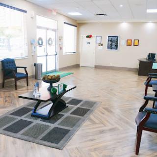 A spacious and inviting waiting room with modern furnishings, creating a comfortable atmosphere for visitors.