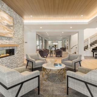 A modern living room with comfortable seating and a cozy fireplace.