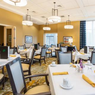 Elegant dining room with neatly set tables and modern decor.
