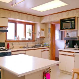 A cozy kitchen with modern appliances and a spacious countertop.