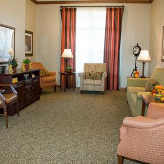 A cozy living room with comfortable seating and warm lighting.