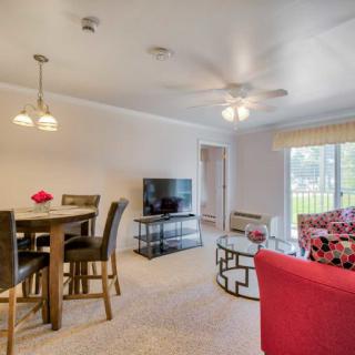 Spacious living and dining area with stylish furniture and natural lighting.