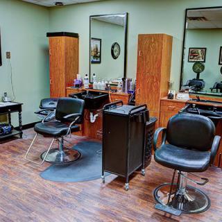 A neat and well-organized hair salon interior with styling chairs and mirrors.