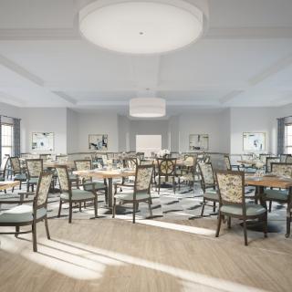 A spacious and elegantly designed dining area with multiple tables and chairs arranged neatly.