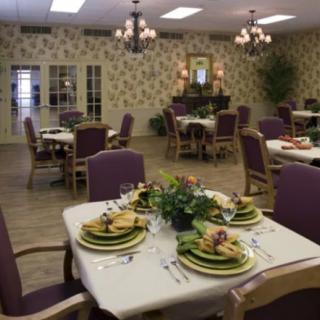 An elegantly decorated dining room with neatly set tables and comfortable chairs.