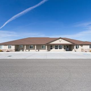A welcoming residential building under a clear blue sky.