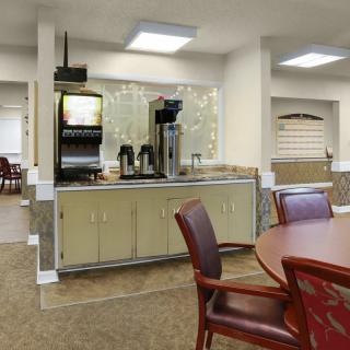 A cozy indoor cafe area with a coffee station and comfortable seating.
