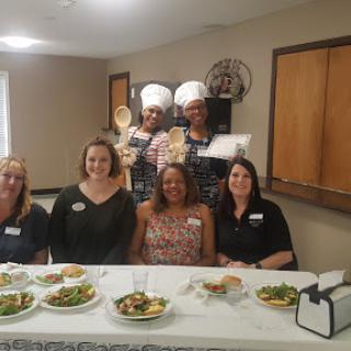 A delightful gathering featuring chefs and guests enjoying a culinary experience.