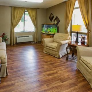 Cozy living room with wooden flooring and an aquarium.