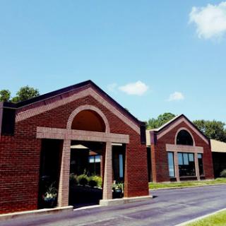 A view of a modern brick building under a clear blue sky.