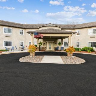 A commercial building with a landscaped entrance and a welcoming driveway.