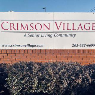 Sign for Crimson Village, a senior living community.