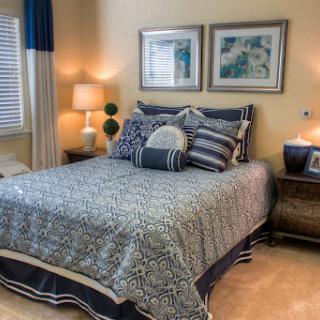 A beautifully designed bedroom featuring a cozy bed with stylish bedding and elegant decor.