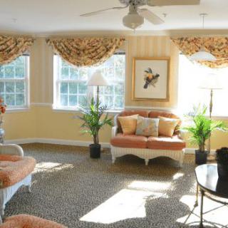 A well-lit living room with elegant furniture and decor.