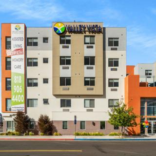 A modern hotel building with colorful exterior located in an urban setting.