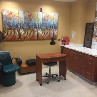 A well-appointed manicure station in a nail salon featuring modern artwork and comfortable seating.