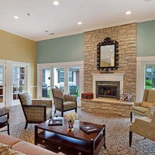 A cozy living room featuring a stone fireplace and comfortable seating.