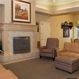 A cozy living room with a fireplace and comfortable seating.