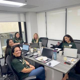 A group of women collaborating in a modern office setting.