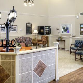 A reception area with comfortable seating, decorative lighting, and welcoming decor.