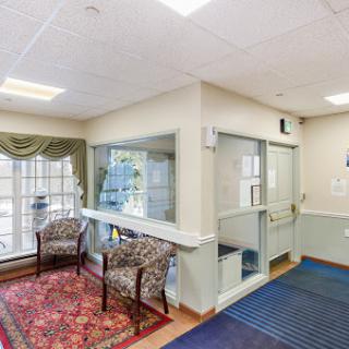 A welcoming waiting area featuring comfortable chairs and a decorative rug.
