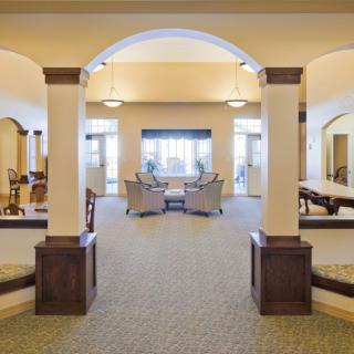 Spacious interior lounge area with arches and seating arrangements.