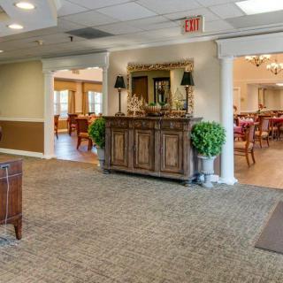 A cozy lobby area with elegant furniture and warm lighting.