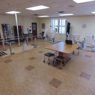 A spacious rehabilitation facility equipped with various exercise machines and a training area.