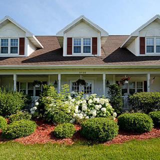 A beautiful suburban house with well-maintained landscaping.
