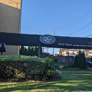 Exterior view of the building with a prominent sign.