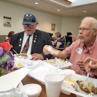 Veterans enjoying a meal together at a community event.