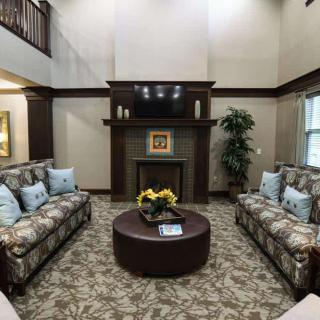 A cozy living room with elegant furniture, a fireplace, and a mounted television.