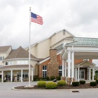 A hotel building with an American flag flying in front.