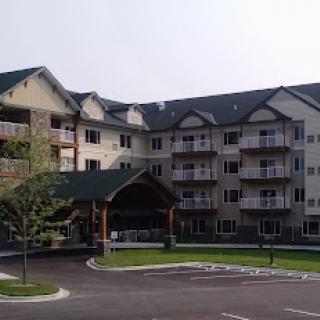 A modern residential building featuring multiple balconies and a welcoming entrance.