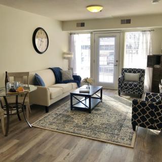 A cozy living room with stylish furniture and large windows allowing natural light.