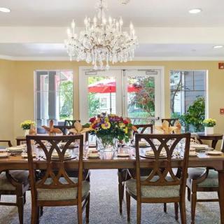 Elegant dining room with a chandelier and a beautifully set table.