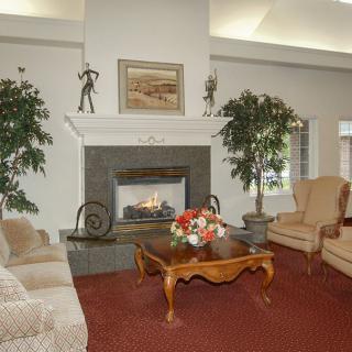 A cozy living room featuring a fireplace, comfortable seating, and decorative elements.