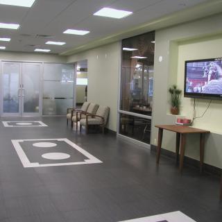A modern lobby with a television and seating area.