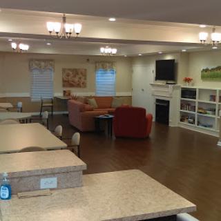 A cozy lounge area with comfortable seating and a television, designed for relaxation and socializing.