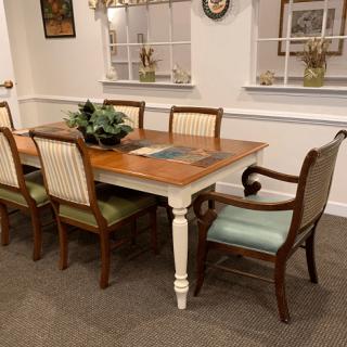 A traditional dining room setup with a wooden table and upholstered chairs.