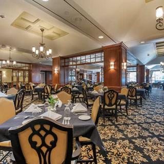 An elegant restaurant dining area with neatly set tables and classic decor.