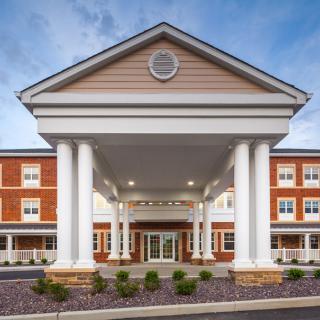 A grand building entrance featuring large columns and a symmetrical facade.