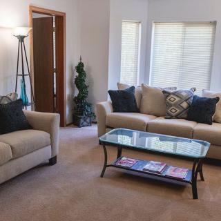 A cozy living room with comfortable seating and natural light.