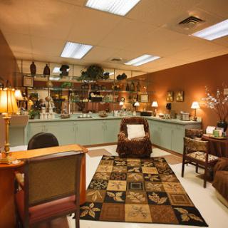 A cozy lounge area featuring comfortable seating, decorative items, and soft lighting.