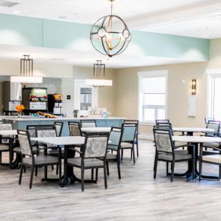 A modern dining area featuring stylish furniture and elegant lighting.