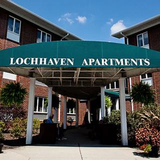 Entrance to Lochhaven Apartments with green awning.