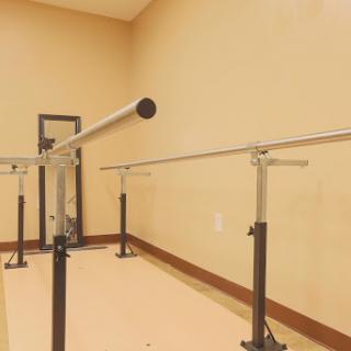 A ballet barre set up in a dance studio for training and practice.