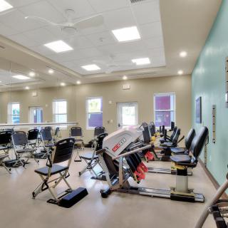 A spacious gym with a variety of stationary bikes and fitness equipment.