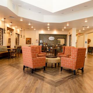 A cozy lobby with comfortable seating and warm lighting.